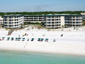 This view shows the Dunes of Seagrove condominiums, the brilliant white sand beach, and beautiful blue-green water of the Gulf of Mexico in Seagrove Beach, Florida.